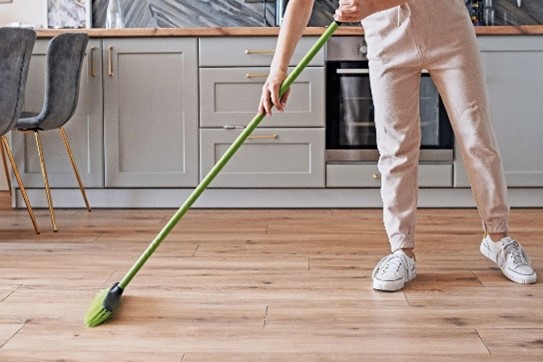 Sweeping the SPC floor regularly to remove any dust and loose dirt